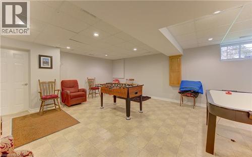 Spacious lower level featuring light-toned tile flooring, recessed lighting, and a window for natural light - 599 Coldstream Drive, Waterloo, ON 