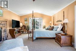 Primary bedroom with vaulted ceiling - 
