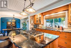 Kitchen with custom island and views to back yard - 