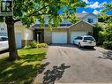 Front exterior featuring light-colored brick and siding accents - 596 Spinnaker Crescent, Waterloo, ON 