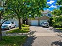 Brick and siding exterior with mature trees - 596 Spinnaker Crescent, Waterloo, ON 