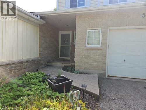 Exterior featuring light-toned brick and vertical siding - 596 Spinnaker Crescent, Waterloo, ON 