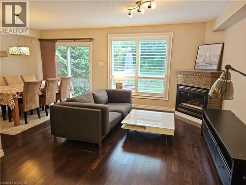 Warmly lit living space featuring rich wood-finish flooring - 596 Spinnaker Crescent, Waterloo, ON 