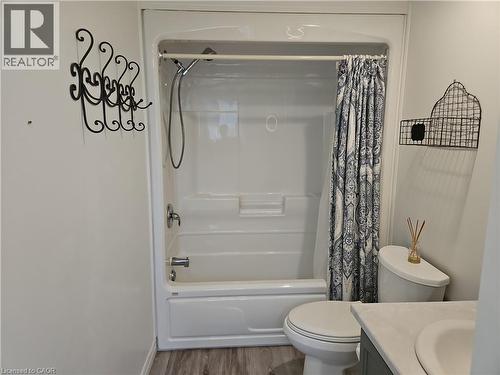 Bathroom featuring a white tub/shower combination, toilet, and a vanity with an integrated sink - 596 Spinnaker Crescent, Waterloo, ON 
