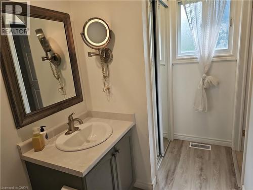 Bathroom vanity with a white oval sink, brushed nickel faucet, and a light-toned countertop - 596 Spinnaker Crescent, Waterloo, ON 