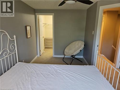 Carpeted room with a ceiling fan, grey wall paint, and white baseboards - 596 Spinnaker Crescent, Waterloo, ON 