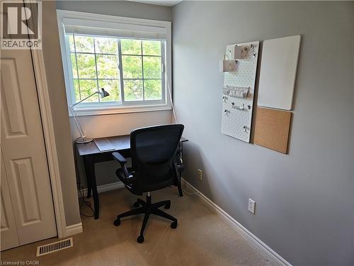 Built-in window with white trim, wood-finish desk, and wall-mounted organization panels - 596 Spinnaker Crescent, Waterloo, ON 