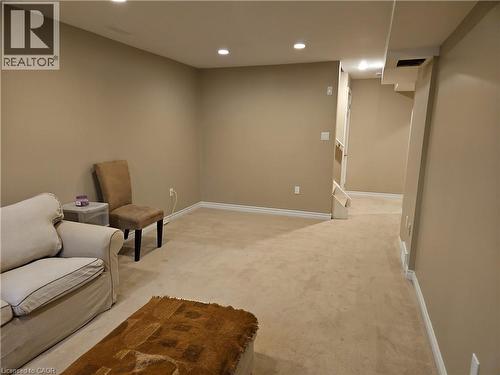 Carpeted lower level featuring recessed lighting, neutral wall paint, and white baseboards - 596 Spinnaker Crescent, Waterloo, ON 