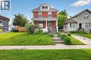 Red brick exterior with white trim, a covered front porch, and a dormer window - 26 Arthur Avenue, St. Thomas, ON 