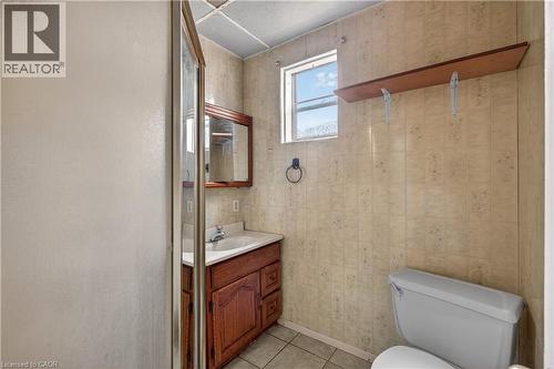 Bathroom featuring a wood vanity with integrated sink, framed mirror, and a window - 26 Arthur Avenue, St. Thomas, ON - Indoor Photo Showing Bathroom