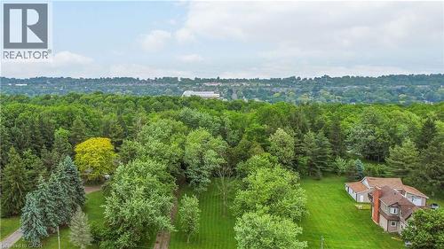 Expansive wooded grounds with a distant skyline - 165 E Ridge Road E, Grimsby, ON 