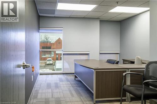 Office space with neutral wall tones and patterned carpet - 5100 South Service Road, Burlington, ON 