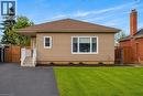 Single-story residence featuring tan siding and a brown shingle roof - 258 Sanatorium Road, Hamilton, ON 