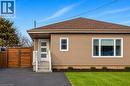 Single-story residence featuring light brown siding and a complementary brown shingle roof - 258 Sanatorium Road, Hamilton, ON 