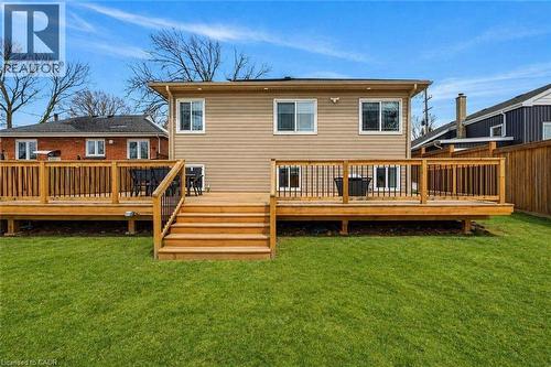 Expansive backyard featuring a manicured lawn, a multi-tiered wood deck with railings, and a siding exterior - 258 Sanatorium Road, Hamilton, ON 