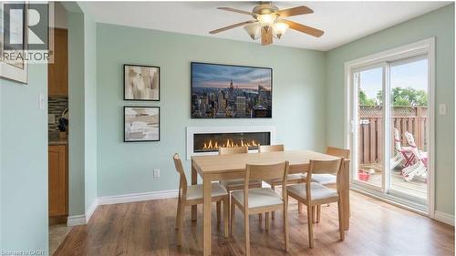 Virtually Staged Dining Area - 817 Acadia Drive, Hamilton, ON - Indoor Photo Showing Dining Room With Fireplace