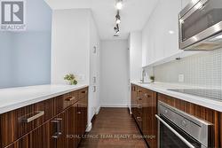 Built-in appliances and quartz countertops. - 