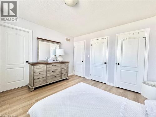 Light-toned wood-finish flooring complements the neutral wall color - 1333 Countrystone Drive, Kitchener, ON 