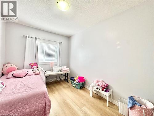 Light wood-finish flooring complements the neutral wall color - 1333 Countrystone Drive, Kitchener, ON 