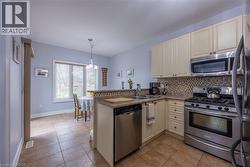 Stainless steel appliances including a gas stove and built-in microwave - 