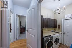 Main floor hallway and laundry room with entry/exit to the garage. - 