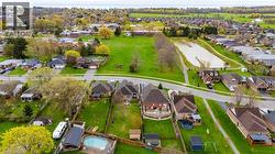 Aerial View from the back of the property showing the school yard and playground which is public after school hours and the public path around the pond with access across the road. - 