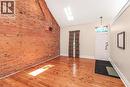 Exposed brick accent wall and natural wood-finish flooring - 18 Pearl Street S, Hamilton, ON 