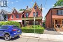 Brick two-story residence with a covered front porch and gabled rooflines - 16 Mulberry Street, Hamilton, ON 