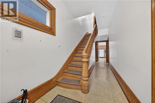 Wood-finish staircase with baluster railing - 16 Mulberry Street, Hamilton, ON 
