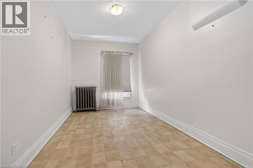 Interior room featuring neutral wall tones, checkered vinyl flooring, and white trim - 16 Mulberry Street, Hamilton, ON 