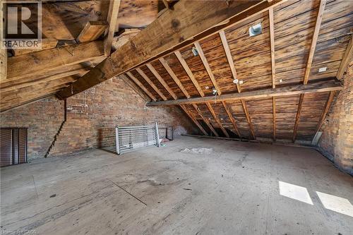 Exposed brick walls defining the perimeter of the space - 16 Mulberry Street, Hamilton, ON 