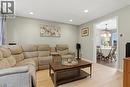 Recessed lighting illuminates the living area featuring light wood-finish flooring and a wide doorway to the dining space - 116 Scott Road, Cambridge, ON 