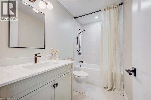 Bathroom featuring a white vanity with a light-toned countertop, an undermount sink, and a bronze-finish faucet - 210 Heritage Drive Unit# Upper, Kitchener, ON 