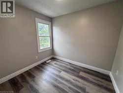 Gray wood-finish flooring complemented by white baseboards - 