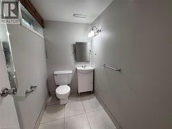 Bathroom featuring light grey walls and large format floor tiling - 