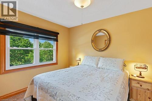 Double-hung window with wood trim, featuring a dark roller shade - 3786 Old Beverly Road, North Dumfries, ON 