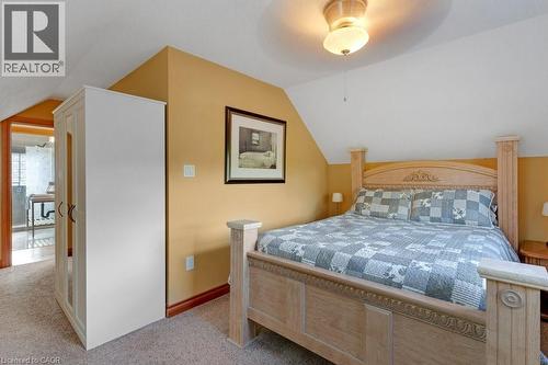 Attic bedroom featuring pitched ceilings and warm wall tones - 3786 Old Beverly Road, North Dumfries, ON 