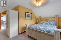Attic bedroom featuring pitched ceilings and warm wall tones - 
