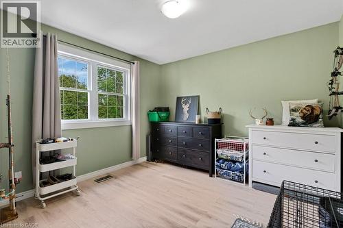 Apartment Room featuring light green wall paint and wood-finish flooring - 3786 Old Beverly Road, North Dumfries, ON 
