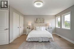 Room featuring wood-finish flooring, light grey painted walls, and white trim - 