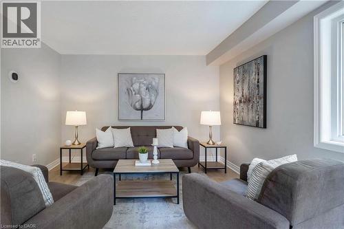Living area featuring light gray walls and wood-finish flooring - 2425 Nichols Drive, Oakville, ON - Indoor Photo Showing Living Room