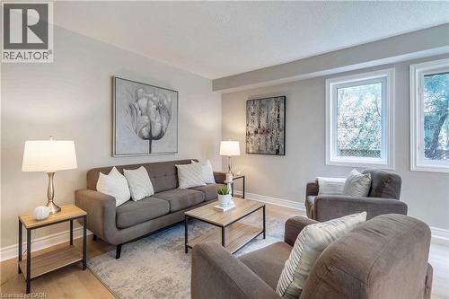 Bright living area featuring light-toned walls, wood-finish flooring, and white trim - 2425 Nichols Drive, Oakville, ON - Indoor Photo Showing Living Room