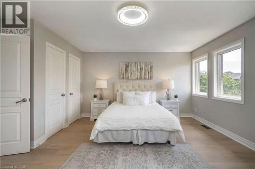 Room featuring wood-finish flooring, light grey painted walls, and white trim - 2425 Nichols Drive, Oakville, ON - Indoor Photo Showing Bedroom