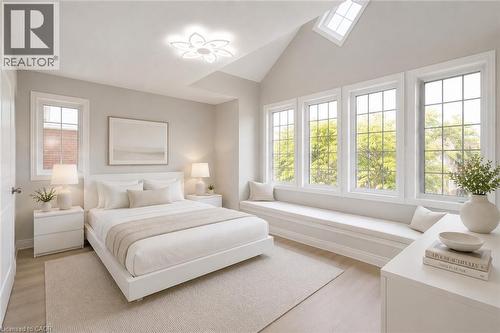 Vaulted ceiling room featuring a wall of multiple pane windows, a built-in window seat, a ceiling-mounted light fixture, and light-tone wood-finish flooring - 2425 Nichols Drive, Oakville, ON - Indoor Photo Showing Bedroom