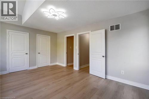 Light wood-finish flooring with white baseboards throughout - 2425 Nichols Drive, Oakville, ON - Indoor Photo Showing Other Room