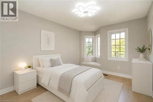 Bright room featuring light grey walls, wood-finish flooring, a contemporary ceiling light fixture, a window seat with cushions, and multiple windows - 2425 Nichols Drive, Oakville, ON - Indoor Photo Showing Bedroom