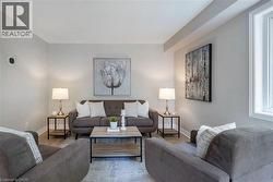 Living area featuring light gray walls and wood-finish flooring - 