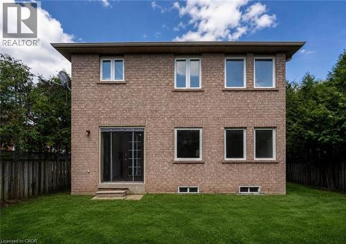 Brick exterior with a sliding glass door and concrete steps to a manicured lawn - 2425 Nichols Drive, Oakville, ON - Outdoor With Exterior