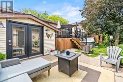 Lower patio with entrance to downstairs sunroom - 