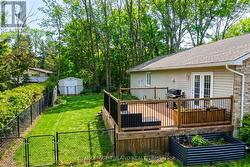 Showing fenced in yard with deck & garden shed - 